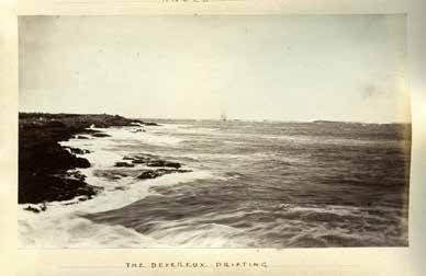 A period photograph captioned 'The Devereux Drifting', showing the ship aground offshore in heavy surf