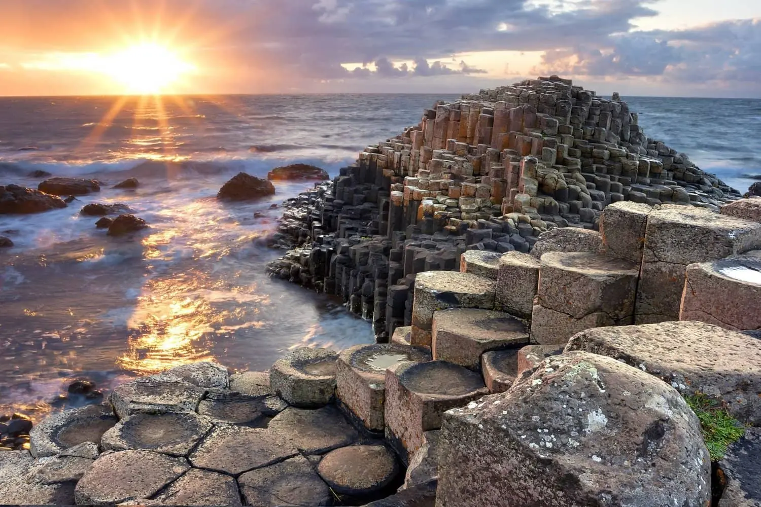 The Giants Causeway at sunrise looking out over the basalt columns towards the sea